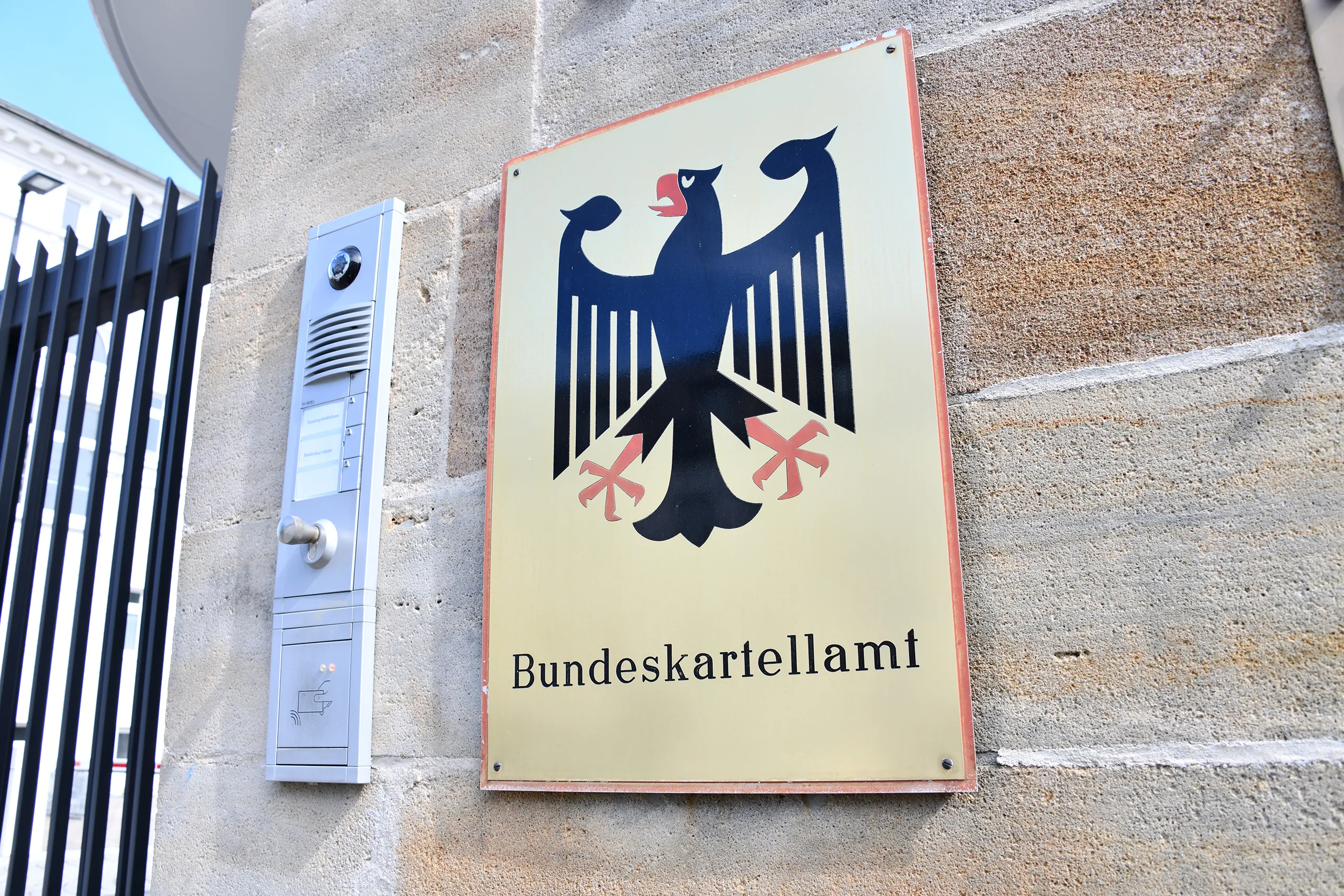 The bundeskartellamt sign with the german eagle emblem outside the building, representing the authority's role in regulating competition, notably through its 2023 ruling against google.