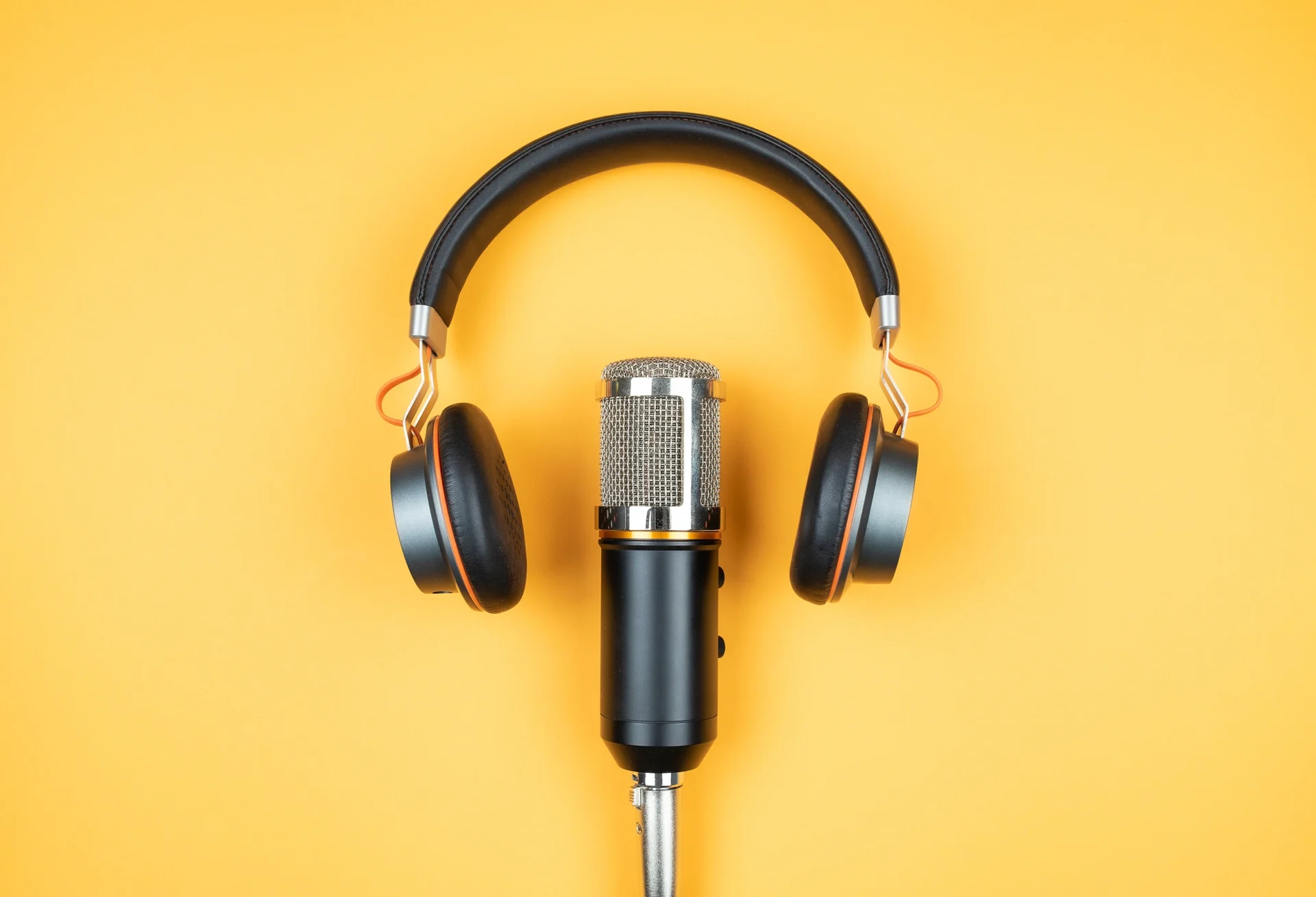 Notebooklm podcast microphone and headphones on a vibrant yellow background