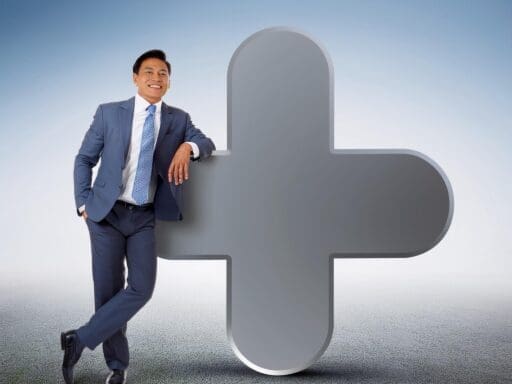 Businessman standing next to a large plus symbol, representing the process of signing up for notebooklm plus.